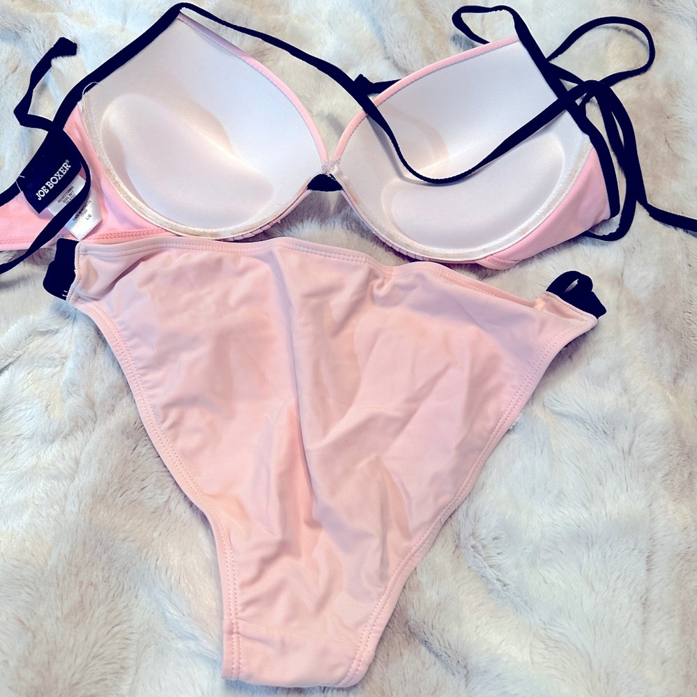Bikini suit pink with black trim.